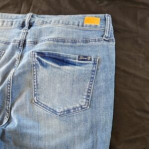 7 Seven Blue Straight Leg Jeans with Subtle Fading and Distressing